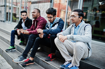 Group of four indian teen male students. Classmates spend time together.