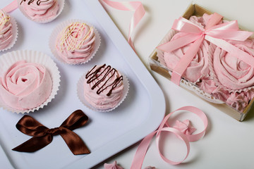 Aerial pink cherry marshmallows. Different shapes and sizes. Sprinkled with dextrose. Garnished with Chocolate.