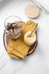 condensed coconut milk and Chocolate Shavings. Raw cacao mass