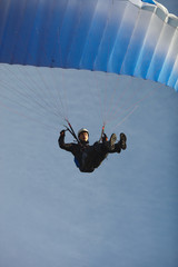 Young athlete is piloting a canopy of a parachute close-up. Speed flying.