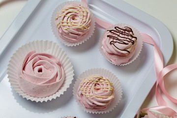 Aerial pink cherry marshmallows. Different shapes and sizes. Sprinkled with dextrose. Garnished with Chocolate.