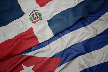 waving colorful flag of cuba and national flag of dominican republic.