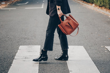 fashion blogger autumn 2019 outfit details. fashionable woman wearing black jeans, black ankle...