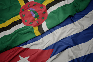 waving colorful flag of cuba and national flag of dominica.