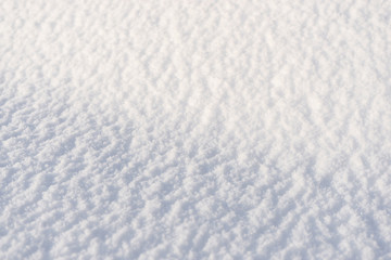 Background from white soft snow with sunlight. Copy space.
