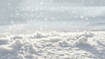 Sparkling white snow with a soft blurry background and snowflakes. Copy space. The concept of a...