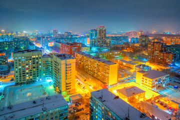 Beautiful top view of the city. Colorful street lighting of the night metropolis. Many high-rise...