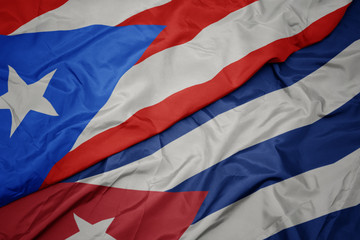 waving colorful flag of cuba and national flag of puerto rico.
