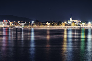 Fototapeta na wymiar Views of the waterfront and St. Pierre Cathedral at night. Switzerland.