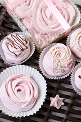 Aerial pink cherry marshmallows. In a gift box with a transparent cover. Near the marshmallows without packaging. Against the background of wicker vines.
