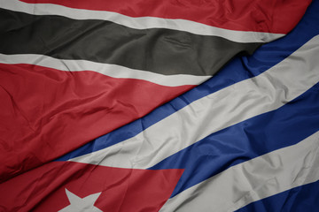 waving colorful flag of cuba and national flag of trinidad and tobago.