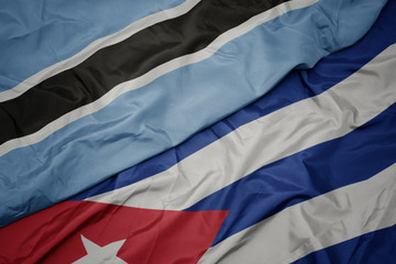 waving colorful flag of cuba and national flag of botswana.