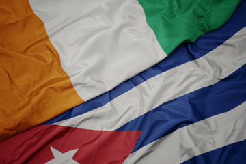 waving colorful flag of cuba and national flag of cote divoire.