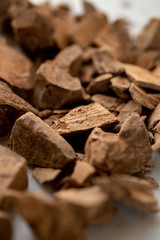Chocolate Shavings background. Raw cacao mass. Raw vegan chocolate