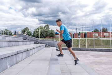 Athletic man running, jogging stairs, training in city during summer, an active lifestyle, modern...