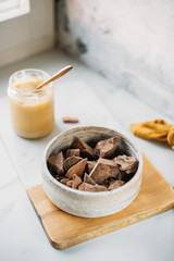 condensed coconut milk and Chocolate Shavings. Raw cacao mass