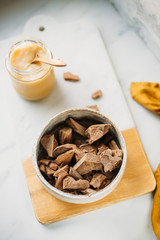 condensed coconut milk and Chocolate Shavings. Raw cacao mass