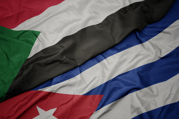 waving colorful flag of cuba and national flag of sudan.