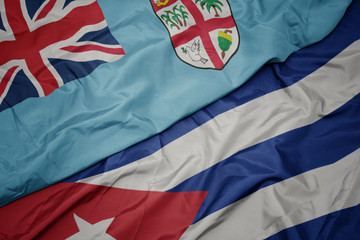 waving colorful flag of cuba and national flag of Fiji .