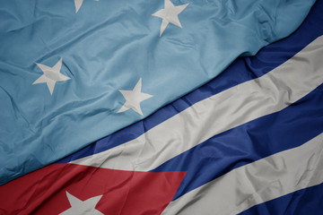 Fototapeta premium waving colorful flag of cuba and national flag of Federated States of Micronesia .