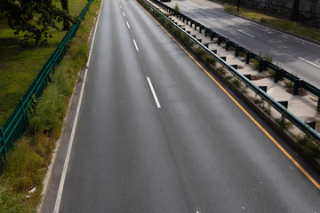 Divided urban highway, overhead view with concrete and guardrail median, horizontal aspect