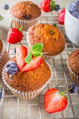 Homemade vanilla muffins or cupcakes with berries
