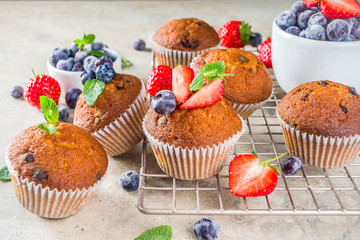 Homemade vanilla muffins or cupcakes with berries