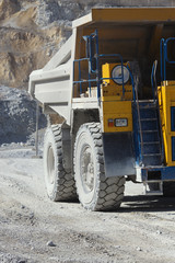 Details of the construction of a mining dump truck, close-up, front view. Heavy equipment. Mining industry.