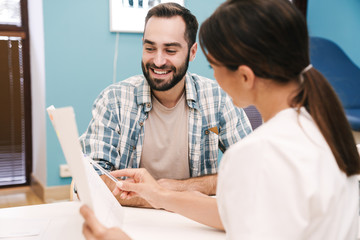 Image of female doctor and patient man looking at health results