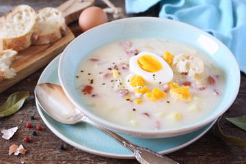 Traditional polish soup Zurek. Sour soup with sausage,  potatoes and eggs