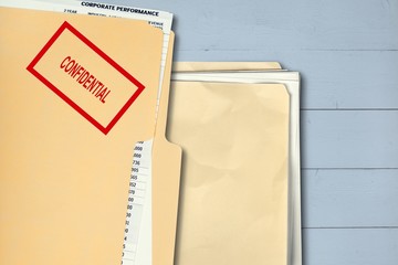 Folder with confidential papers on table