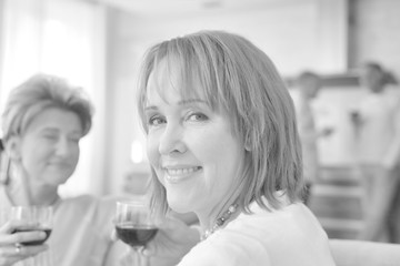 Close up of smiling senior woman drinking wine