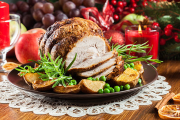 Roasted pork ham served with baked potatoes