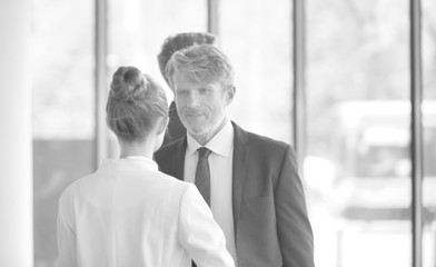 Businessman discussing with young businesswoman at new office