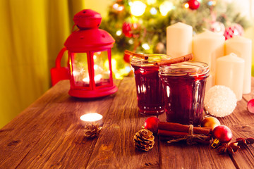 Christmas mulled wine on wooden plank over christmas tree