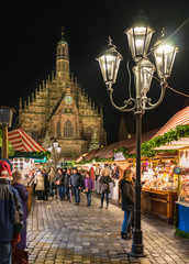 Nuremberg christmas market with illuminated stalls at night - 299097809
