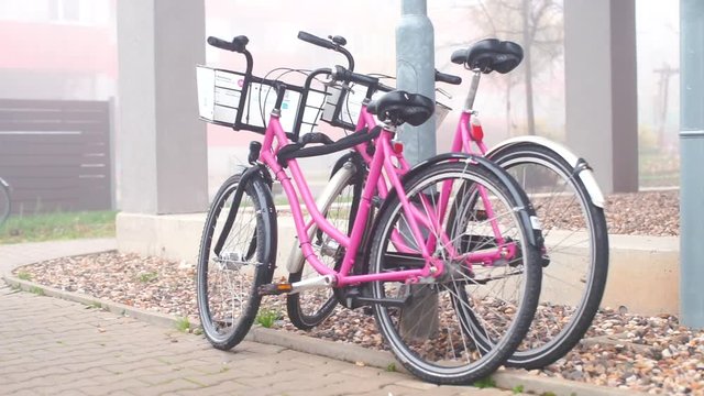 Pink bikes parked near a residential building