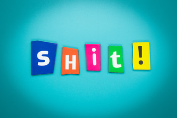 Word - shit! - on blue background. Cut colorful letters. Card, banner with inscription. Text message. Expression concept.
