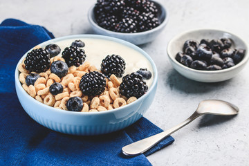 Bowl filled with corn ring cereals and berries. Healthy breakfast
