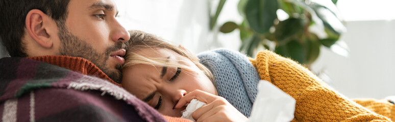 diseased couple lying in bed with napkins