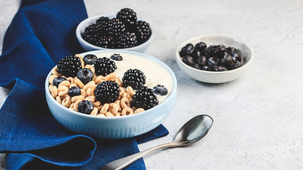 Bowl filled with corn ring cereals and berries. Healthy breakfast