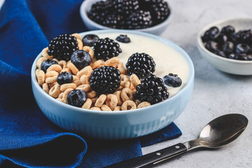Bowl filled with corn ring cereals and berries. Healthy breakfast