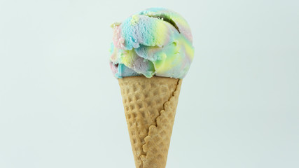 Ice cream Rainbow colorful scoop in waffle cone on white background, Closeup Front view Food concept.