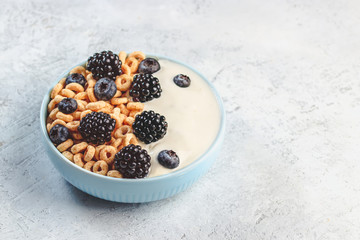 Bowl filled with corn ring cereals and berries. Healthy breakfast
