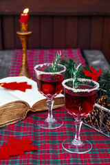 Christmas still life , two glass with red raspberry beverage decorated with rosemary , vintage old fashion style.