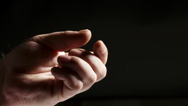 Hand tossing a coin. Throwing silver Deutsche Mark coin in the air close-up.
