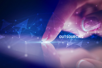 Finger touching tablet with OUTSOURCING inscription, business concept