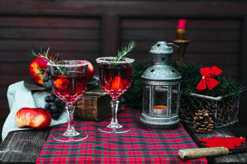 Christmas still life , two glass with red raspberry beverage decorated with rosemary , vintage old fashion style.