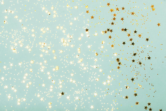 Trendy mint background with gold stars. The concept of celebrations, the Day of St. Valentine, Christmas, New Year, holiday, birthday, etc.