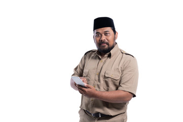 business worker with brown uniform indonesia smiling while using mobile phone isolated over white background